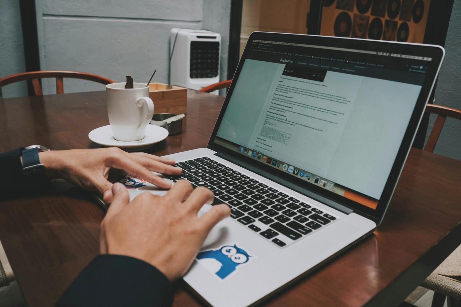 Person analysiert Finanzdokumente am Schreibtisch